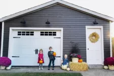 Kinds in front of a garage door