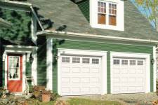 A picture of 2 single garage doors in Classic CC design, 9' x 7', Ice White color, 4 lite Orion windows