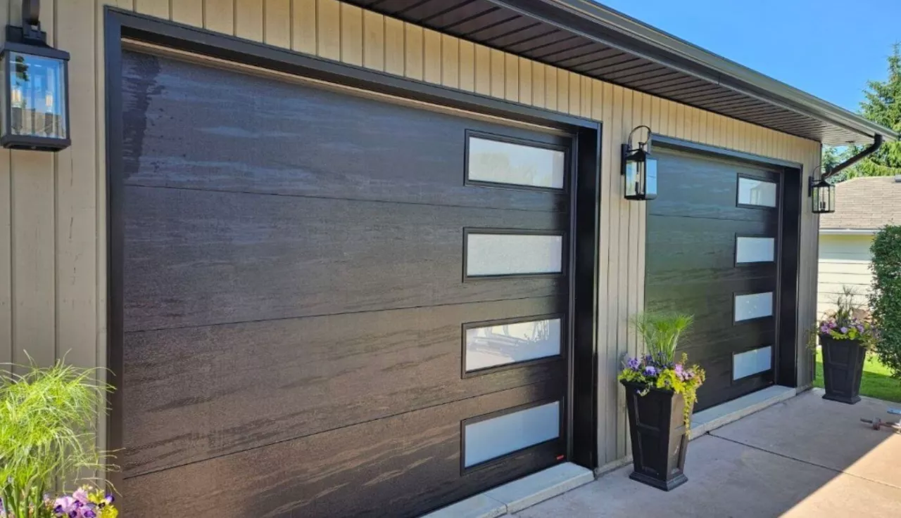 Garage doors with two planters on either side, creating a welcoming and aesthetic frame.